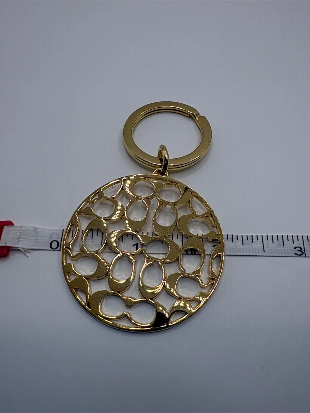Coach Gold Logo Cutout Circle Keychain